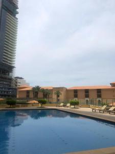 a large swimming pool in front of a building at Palm view hostel in Dubai
