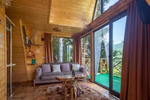 a living room with a couch and a table at Forest House in Dandalo