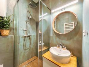 a bathroom with a shower and a sink and a mirror at Botaniq Room in Gyula