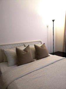 a white bed with pillows on it in a room at T STAY at Icon Residence -for 1 Room Free Netflix & Pool in Kuala Terengganu +15 photos