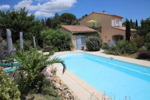 a large swimming pool in front of a house at Gite ARCADIA in Saint-Ambroix