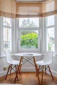 a table and two chairs in a room with a window at Tasteful & Homely 1BD Flat - Brixton in London