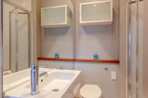 a bathroom with a sink and a toilet and a shower at Tasteful & Homely 1BD Flat - Brixton in London