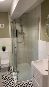 a bathroom with a shower and a sink at BridgeCity Spectacular Morden 2 bedroom flat in Ashford Town Centre in Kent