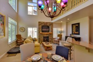 a living room with a fireplace and a chandelier at Dog-Friendly Huntsville Vacation Rental with Pool! in Huntsville