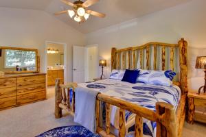 a bedroom with a wooden bed and a bathroom at Dog-Friendly Huntsville Vacation Rental with Pool! in Huntsville +30 photos