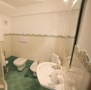 a bathroom with a white sink and a toilet at La Lanterna in Cetara +3 photos