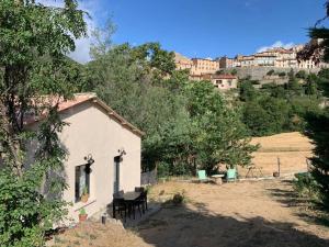 a small white house in the middle of a field at Casa del Sola in Mosset