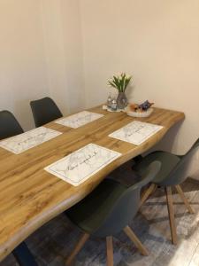 a wooden table with four chairs around it at Ferienwohnung Krayenbergblick 2 in Tiefenort