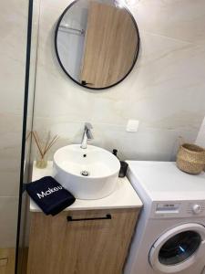 a bathroom with a sink and a washing machine at Thalassa Grammeno seaview house in Palaiochora +7 photos