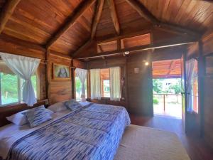 a bedroom with a large bed in a room with wooden ceilings at Galapagos Cabañas Eden in Bellavista