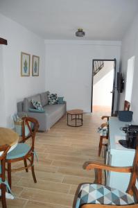 a living room with a couch and a table and chairs at Nuestra casa en Vejer in Vejer de la Frontera