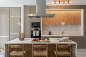 a kitchen with a table with chairs and appliances at Uptown 13 apartment by An Island Apart in Funchal