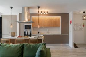 a kitchen with a couch in a living room at Uptown 13 apartment by An Island Apart in Funchal