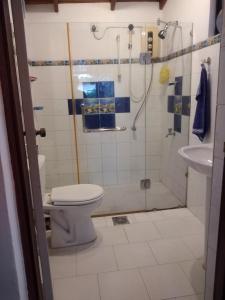 uma casa de banho com um chuveiro, um WC e um lavatório. em Roche's Cozy Corner R-1 Upper Level em Madiwala