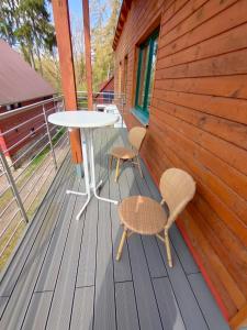 a table and two chairs on a wooden deck at Sonnenhaus in Joachimsthal