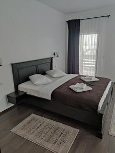 a bedroom with a large bed and a window at Pensiunea Tincu in Satu Şugatag +47 photos