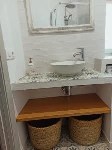 a bathroom with a sink and a mirror at Nuestra casa en Vejer in Vejer de la Frontera