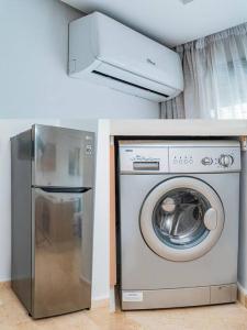 a washing machine and a refrigerator in a room at Un charmant duplex à proximité de la corniche in Casablanca