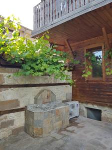 a stone fireplace on the side of a building at Nikoli - Nesebar Traditional House in Nesebar