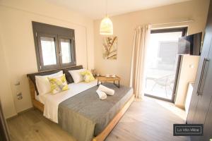 Postel nebo postele na pokoji v ubytování La Vita Villas