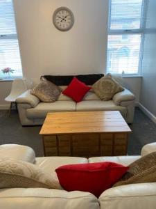 a living room with a couch and a coffee table at Apartments on Albert Road with free parking in Blackpool