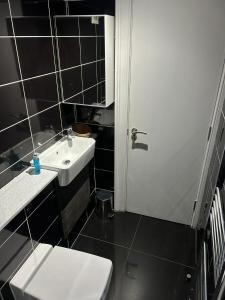 a bathroom with a white toilet and a sink at Twin Room With En-Suite in Edinburgh