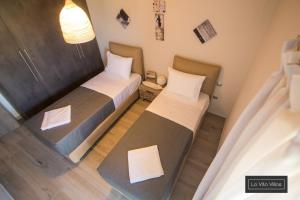 Postel nebo postele na pokoji v ubytování La Vita Villas