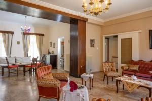 a living room with a couch and tables and chairs at Mansion House in Neápolis
