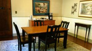 a dining room with a wooden table and chairs at Rock Cottage Gardens B&B in Eureka Springs