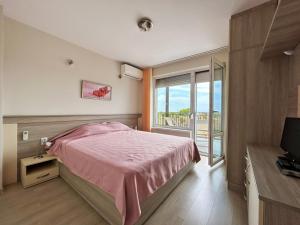 a bedroom with a pink bed and a window at Golf Villa Ariel in Kavarna +32 photos