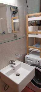 a bathroom with a white sink and a bunk bed at Apartma Anja in Zgornje Gorje