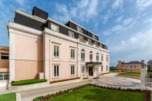 a large white building with a courtyard at Olissippo Lapa Palace – The Leading Hotels of the World in Lisbon