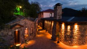an old stone building with lights on it at night at GAFULLUK BUNGALOV in Araklı