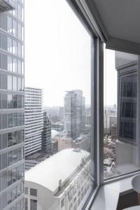 a view of a city from an office window at Yorkville Luxe High-End Prime Downtown Location in Toronto