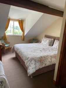 a bedroom with a bed and a window at Arkleside Country Guest House in Reeth