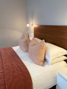 a bedroom with a bed with pillows on it at Belgravia Apartments in London