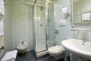 a bathroom with a shower and a toilet and a sink at Hotel Iris in Genoa