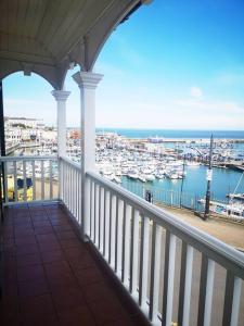 a balcony with a view of a marina with boats at Magnificent house with Harbour view - Ramsgate in Ramsgate