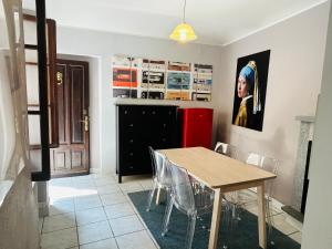 a dining room with a table and a painting on the wall at La casetta di Bianca - MonferratoHome in Frassinello Monferrato