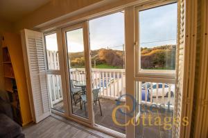 a view from the balcony of a house at Sandunes House in Camber