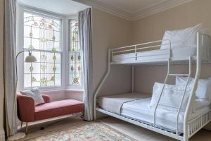 a bedroom with two bunk beds and a window at Magnificent house with Harbour view - Ramsgate in Ramsgate
