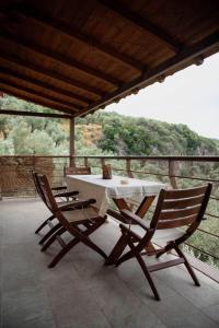 a table and chairs on a balcony with a view at Luxury Mansion in Pelion Hills in Afissos