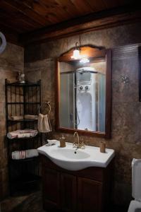 a bathroom with a sink and a mirror at Luxury Mansion in Pelion Hills in Afissos