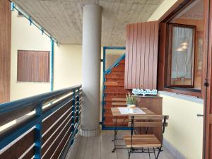 a balcony with a table and chairs on it at Casa Nevosa by Holiday World in Prato Nevoso