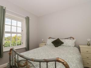 a bedroom with a bed and a window at Cherry Tree House in Highbridge