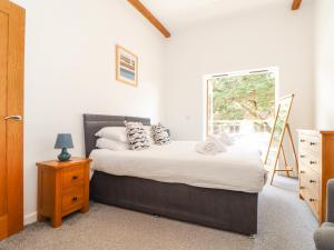 a bedroom with a bed and a window at Tehidy in Truro