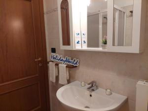 a bathroom with a sink and a mirror at Casa Nevosa by Holiday World in Prato Nevoso +22 photos