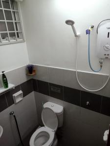 a bathroom with a toilet and a shower at Homestay Camelia Kuala Terengganu Houses 3 Room 2 Bathroom - Near Batu Buruk Beach , Drawbridge, Pasar Payang, KTCC Mall & Hospital HSNZ in Kuala Terengganu