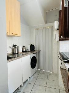 a small kitchen with a washing machine in it at La casetta di Bianca - MonferratoHome in Frassinello Monferrato